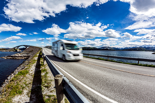 Caravan car RV travels on the highway Norway. Atlantic Ocean Road or the Atlantic Road (Atlanterhavsveien) been awarded the title as (Norwegian Construction of the Century).