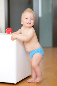 Baby boy with blue eyes standing