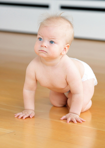 Baby boy crawling on floor