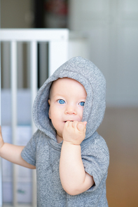 Baby boy with blue eyes learning to walk