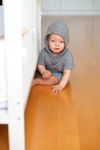 Baby boy with blue eyes learning to walk