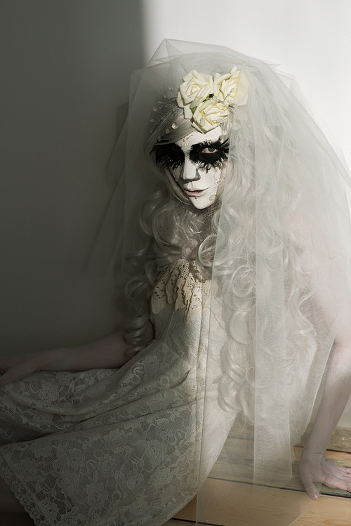 halloween witch. beautiful woman wearing s산타무에르테무에르테 mask and wedding dress. dead widow in grief