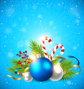 Christmas greeting card with green fir branch and decorations on a blue background.