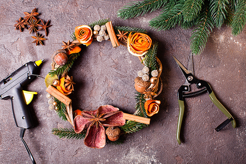 Christmas aromatic eco wreath with dry orange and anise stars, decorated tangerine peel roses, closeup details