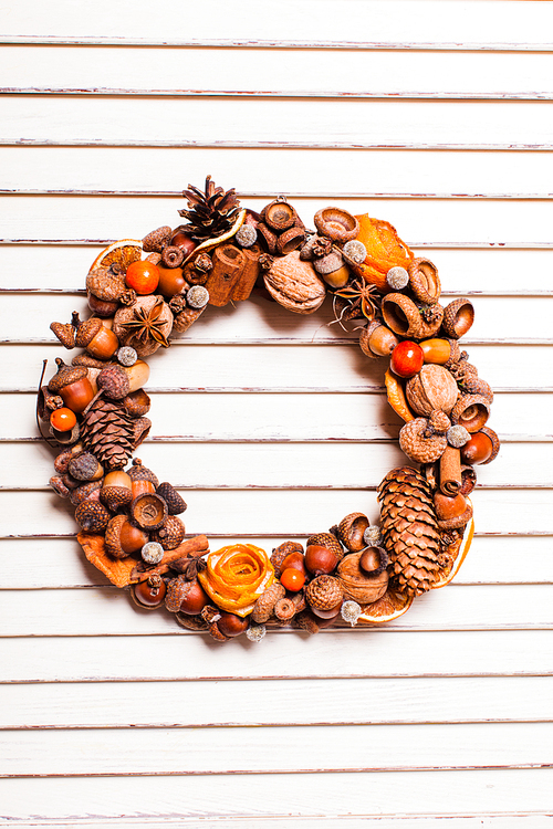 Christmas aromatic wreath from natural components with tangerine roses. Mulled wine style