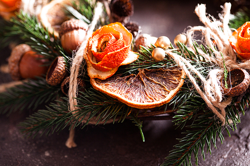 Christmas aromatic eco wreath with dry orange and anise stars, decorated tangerine peel roses, closeup details