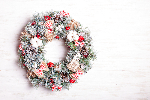 Red and white Christmas wreath with bows and cotton flowers