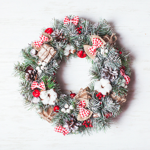 Red and white Christmas wreath with bows and cotton flowers