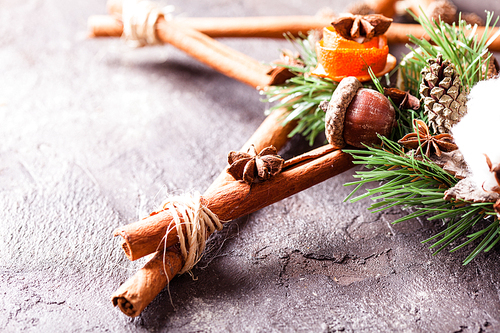 Christmas aromatic decor, cinnamon sticks tied as five-pointed star with rope, acorns and cotton flower