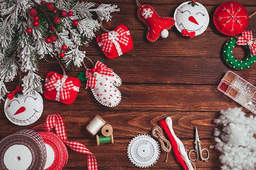 felt Christmas decorations on the wooden table - preparing for handmade