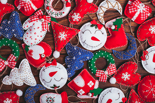 felt Christmas decorations on the wooden table as a background