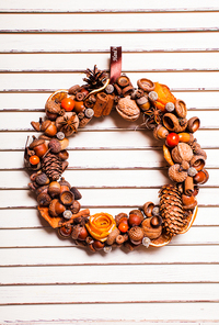 Christmas aromatic wreath from natural components with tangerine roses. Mulled wine style