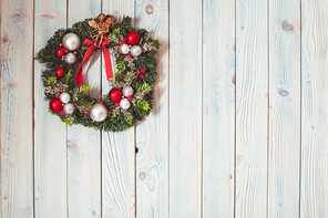 Christmas wreath hanging on blue wooden wall