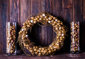 Golden acorns and pine cones in glass and wreath, decor for Christmas