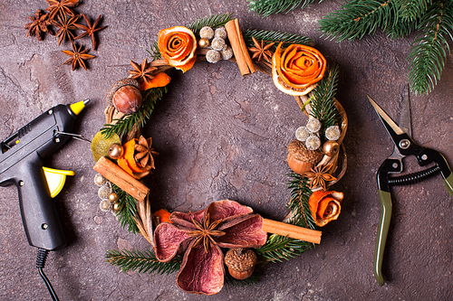 Christmas aromatic eco wreath with dry orange and anise stars, decorated tangerine peel roses, closeup details