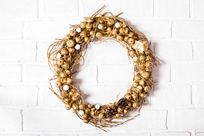 Golden woven natural wreath with acorns and pine cones