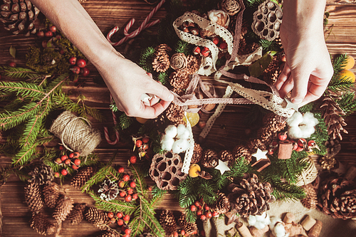 nature components wreath - preparation for making natural  decorations. focus on hands