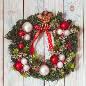 Christmas wreath hanging on blue wooden wall