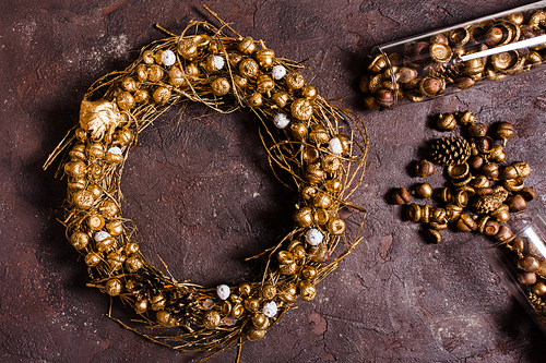 Golden woven natural wreath with acorns and pine cones