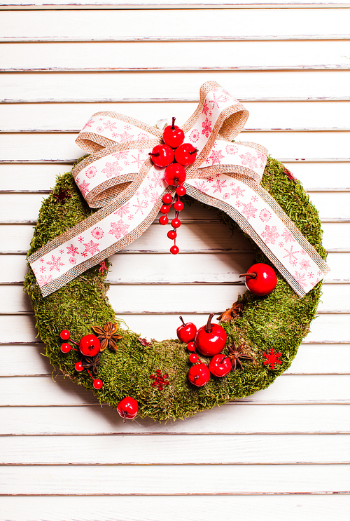 Christmas natural wreath with moss and berries