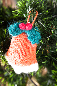 Knitted toy on Christmas tree, close up