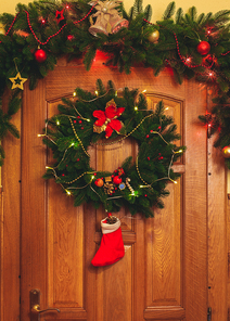 Christmas wreath with red sock and border on the door