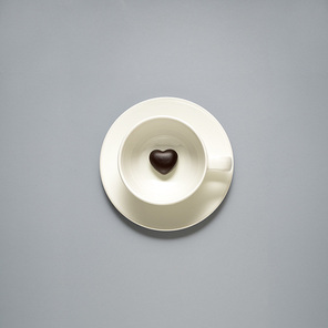 Creative concept photo of kitchenware, painted plate with food on it on grey background.