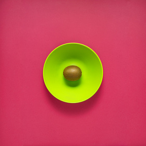Creative concept photo of kitchenware, painted plate with food on it on pink background.