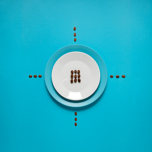 Creative concept photo of kitchenware, painted plate with food on it on blue background.