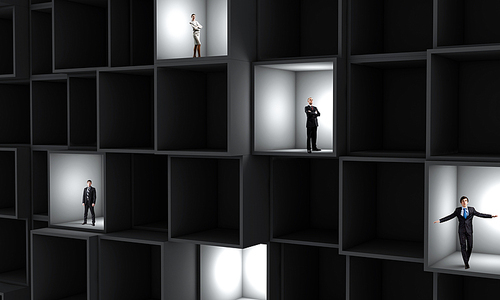 Miniatures of business people standing in cube