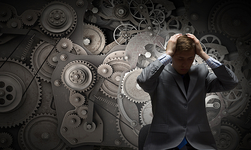 Young troubled businessman with hands on his head