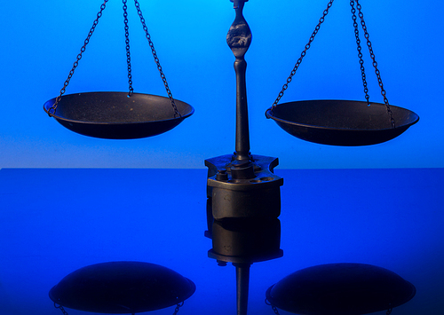 Law antique scales on blue background with copy space