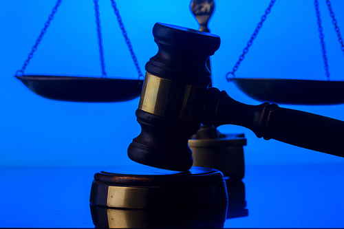 Law and justice concept - law gavel with scale on blue background