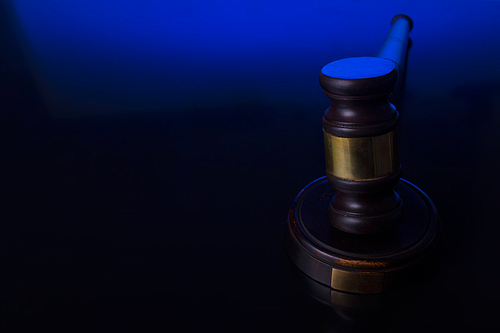 Law and justice concept - law gavel pn blue and black background