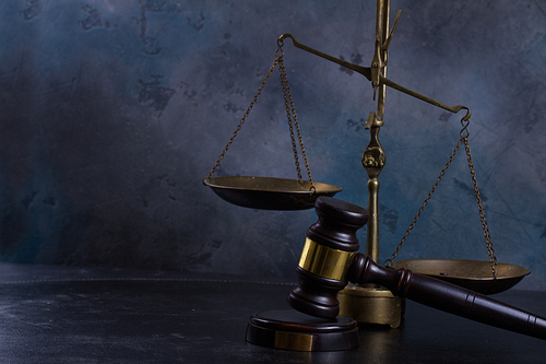 Law and justice concept - law gavel with scale on gray background