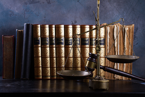 Law and justice concept - law gavel and scale with row of books