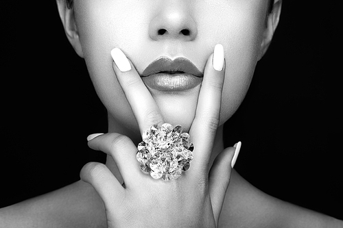 Beauty Fashion woman Lips with natural Makeup and white Nail Polish. Gloss Lipstick. Beauty girl Face close up. Sexy Lips, Manicure, Make up. Ring with Precious Stones, Jewelry