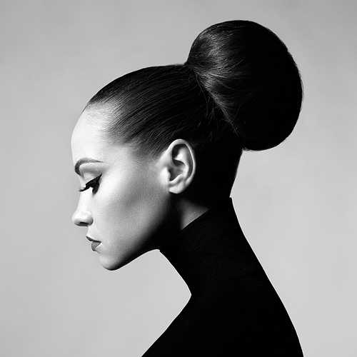 black and white fashion art studio portrait of beautiful elegant woman in black turtleneck.  hair is collected in high beam.  elegant dance style