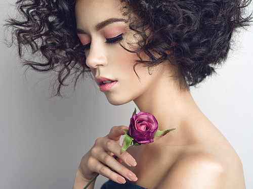 Studio fashion photo of beautiful young woman with violet rose.  Valentines day. Spring blossom