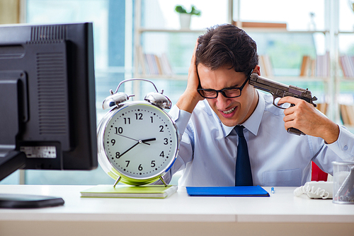 Angry businessman with gun thinking of committing suicide