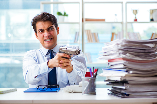 Angry businessman with gun thinking of committing suicide