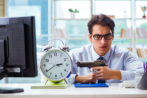 Angry businessman with gun thinking of committing suicide