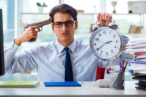 Angry businessman with gun thinking of committing suicide