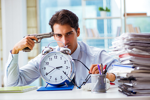 Angry businessman with gun thinking of committing suicide