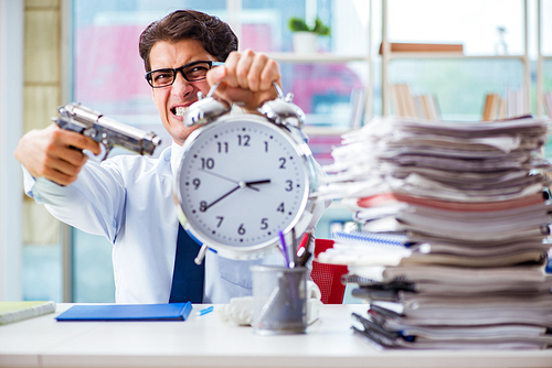 Angry businessman with gun thinking of committing suicide