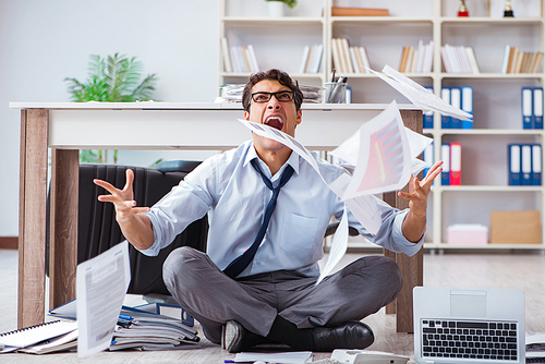 Bankrupt businessman angry in the office floor