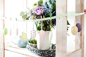 Hanging eggs on the ribbon - Easter decortaions on the shelf indoor