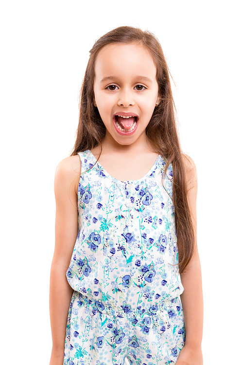 Small girl playing and making a silly expression - isolated over white
