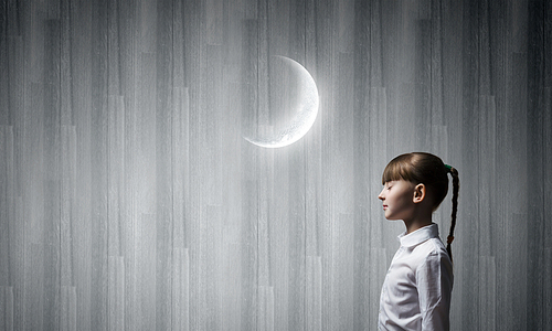 Side view of cute girl and moon above her head