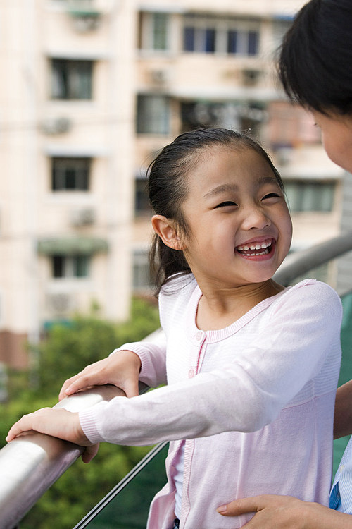 Mother and daughter laughing